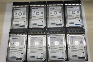 Eight hard drives arranged in two rows, showcasing their labels for identification. Relevant for discussions on data storage solutions.