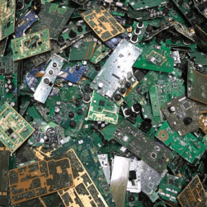 Piled electronic circuit boards illustrate electronic waste, highlighting concerns about environmental impact and recycling efforts.