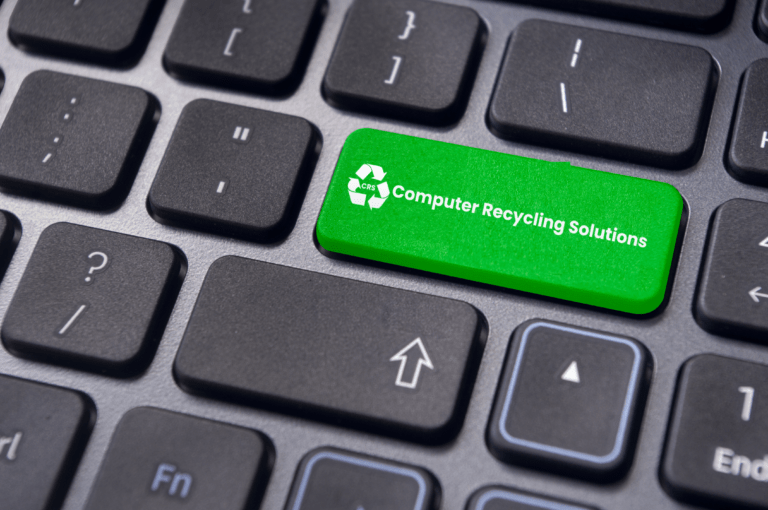 Bright green keyboard key labeled "Computer Recycling Solutions" with a recycling symbol, promoting electronic waste recycling awareness.
